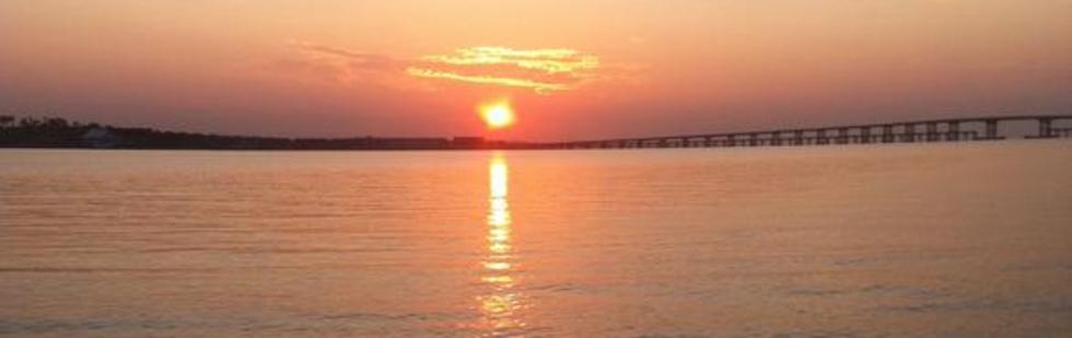 Sunrise over Bob Sikes bridge on fishing charter trip
